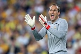 Socceroo Mark Schwarzer shouts encouragement to his team-mates during the 2010 FIFA World Cup qualifying match