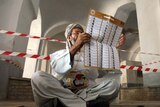 An Afghan election worker counts the presidential election ballots