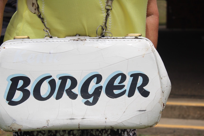 A close up image of a white leather bag, with the name Borger painted on it.