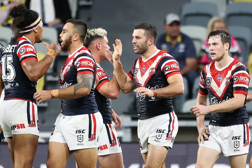 Sydney Roosters NRL players congratulate each other after scoring a try against the North Queensland Cowboys.