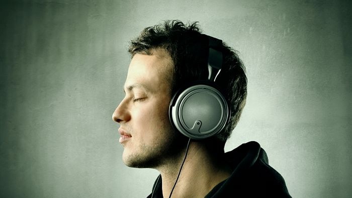 A man with headphones on listening to music