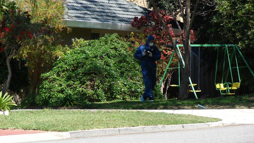 A forensic officer examines Chris Mainwaring's Perth property.