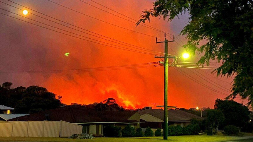 Smoke and the orange glow from flames can be seen from homes in Yanchep