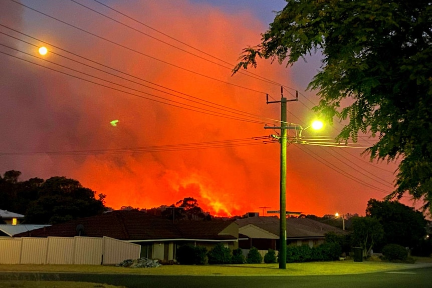 Smoke and the orange glow from flames can be seen from homes in Yanchep