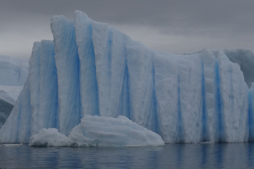 A large chunk of ice that looks slightly blue at Prospect Point in Antarctica.