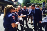 Daniel Andrews greets paramedics after securing a pay deal with the unions.