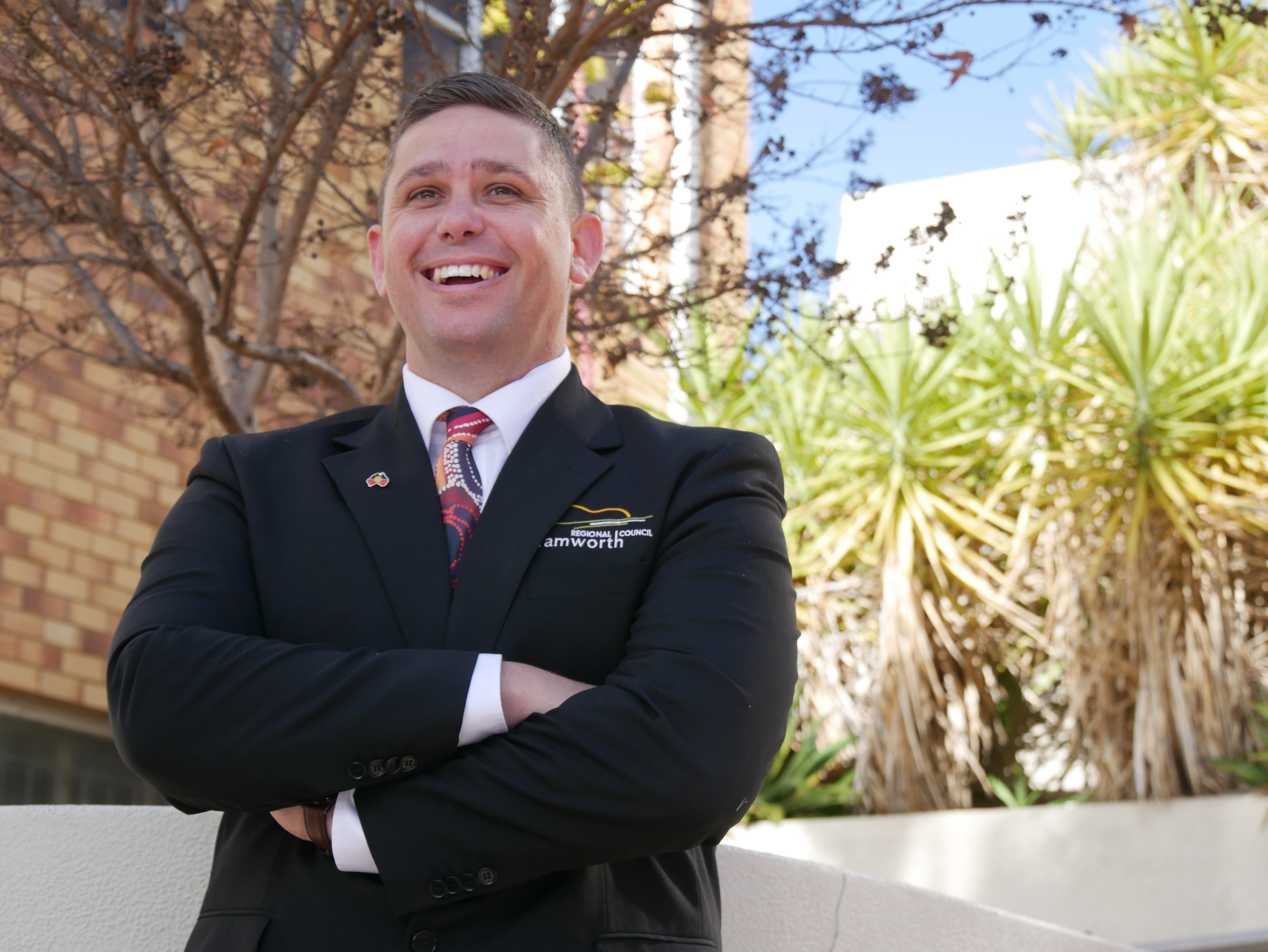Man in suit smiling and laughing