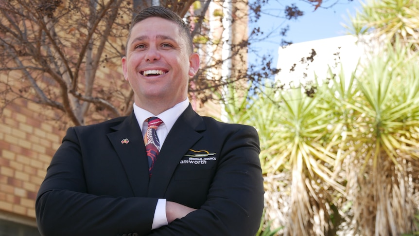 Man in suit smiling and laughing