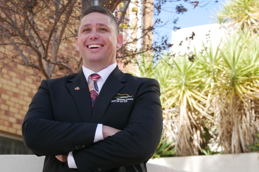 Man in suit smiling and laughing