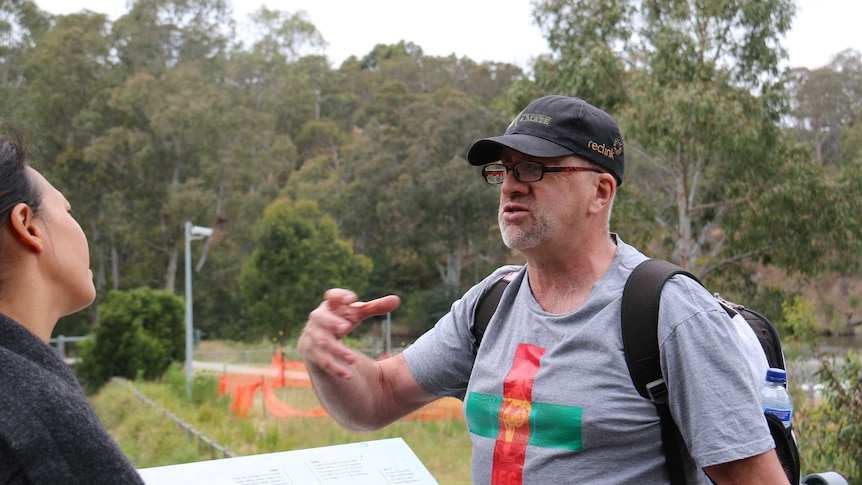 Pete Burns guiding a walking tour of Melbourne.