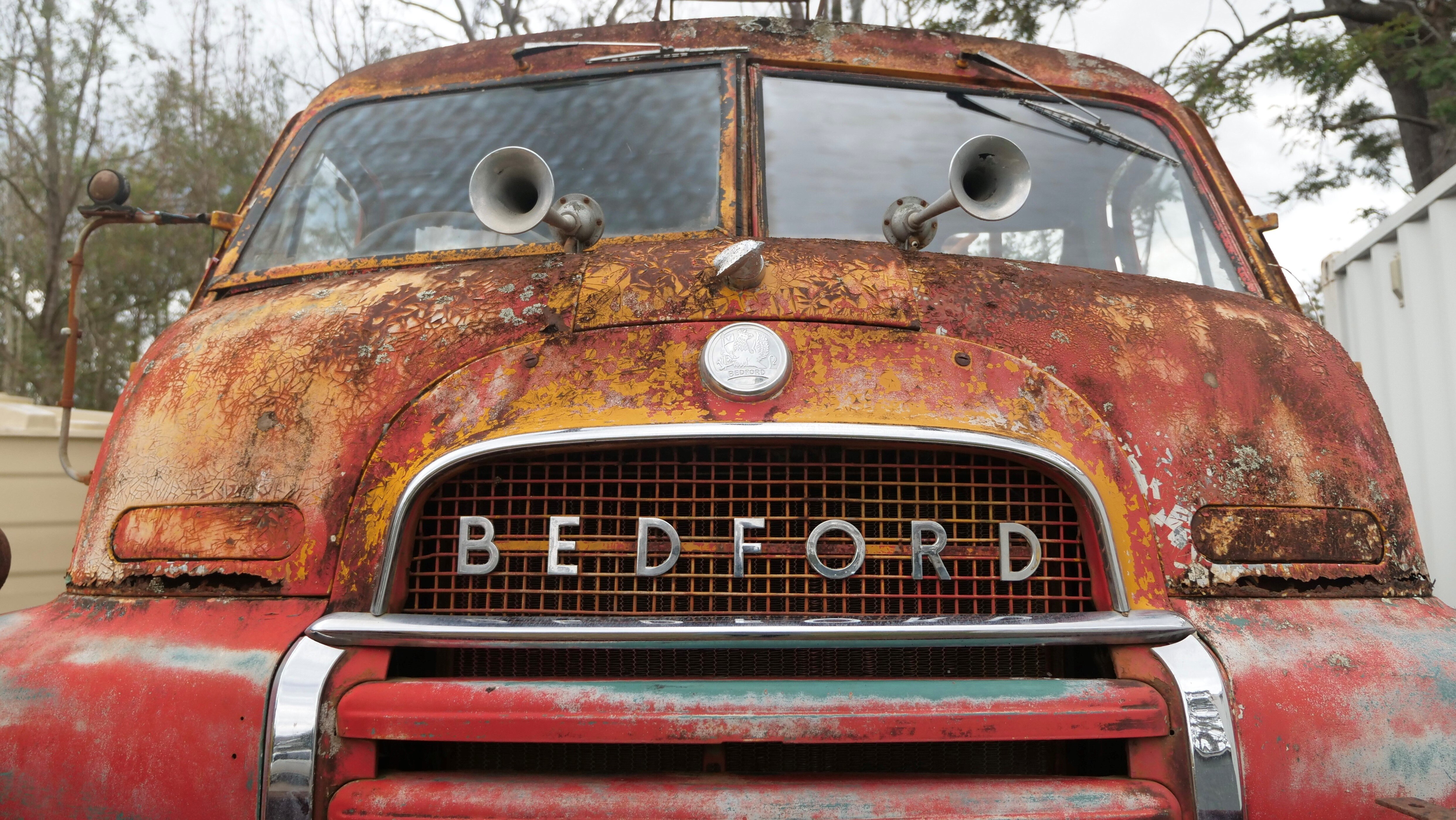 The front of an old truck with the word 'Bedford' across the front.