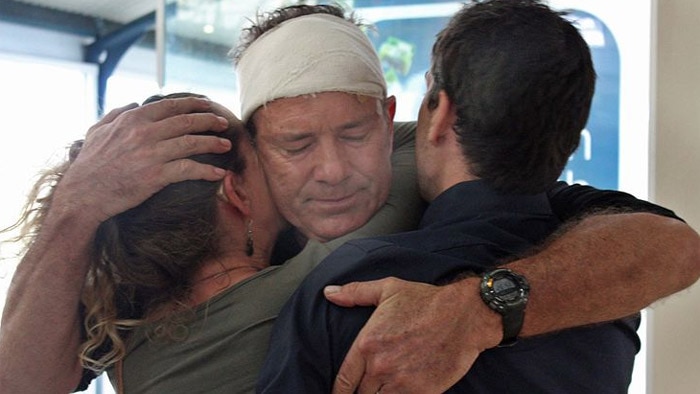 Nick Bennett's family gather around him at the Mackay Airport after PNG attack, September 11, 2013
