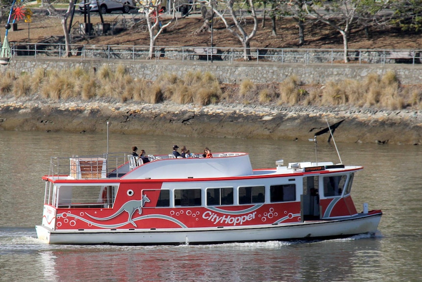 A small red ferry on the Brisbane River.