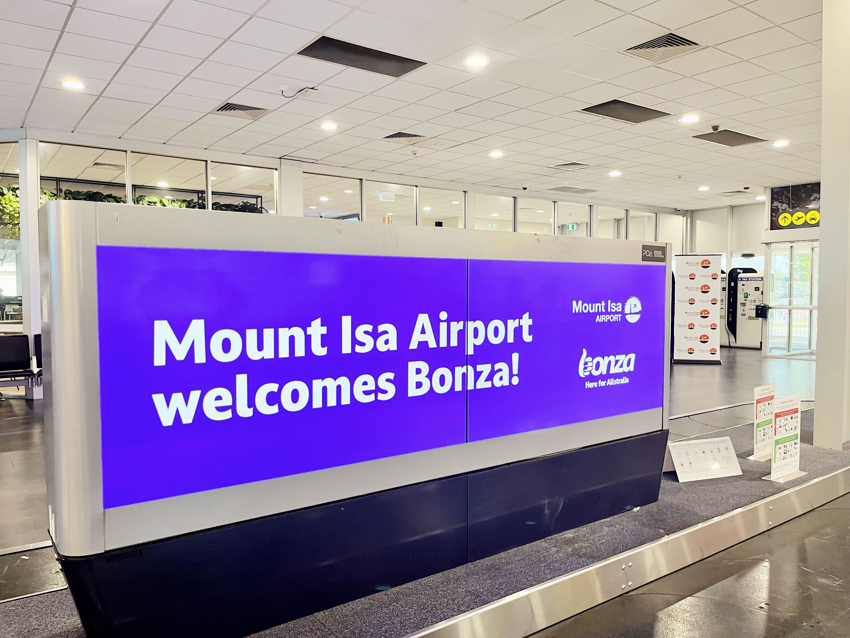 A purple bonza sign in an airport.
