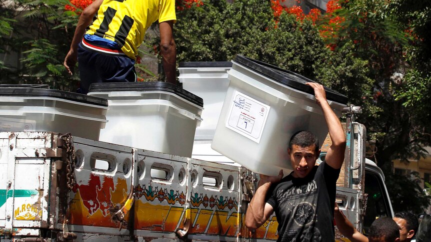 Ballot boxes are carried to a school that is to serve as a polling station in Cairo.