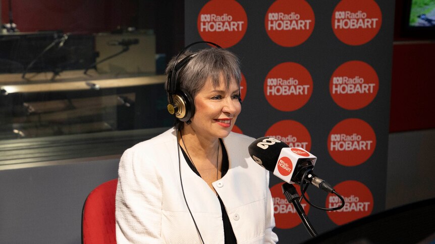 Sue Hickey smiles as she site in the studio's guest chair at ABC Radio Hobart.