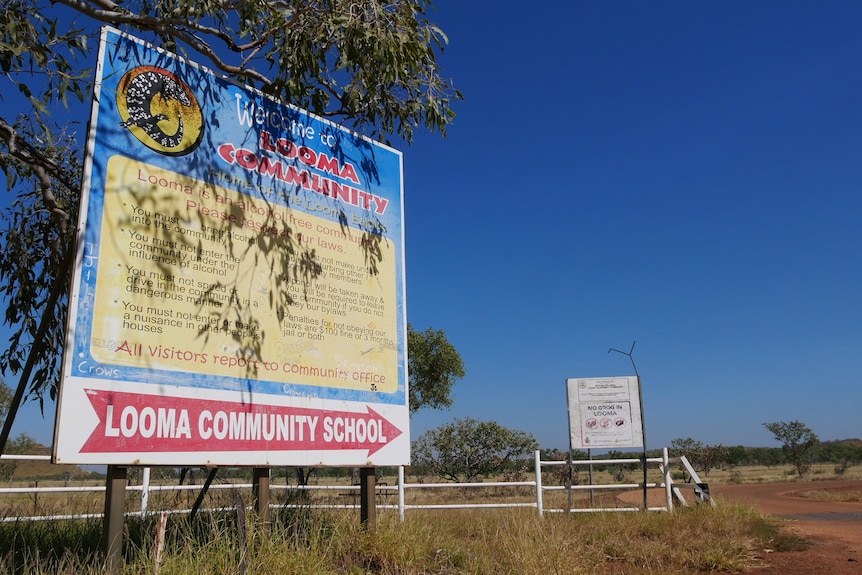 A sign showing the way to the Looma community