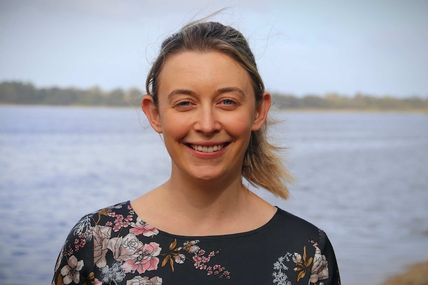 Woman smiling with lake in background