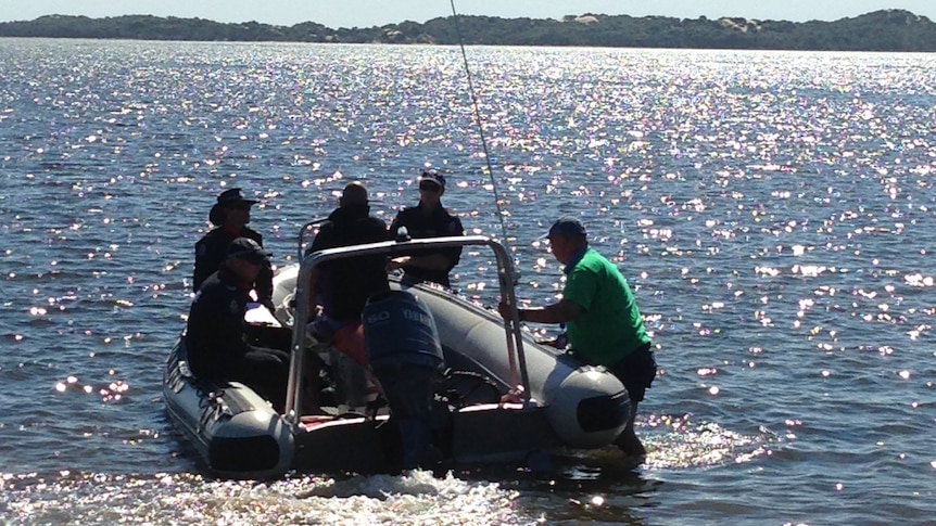Police divers and officers on board an inflatable rubber dinghy in Leschenault estuary searching, after explosives were found.