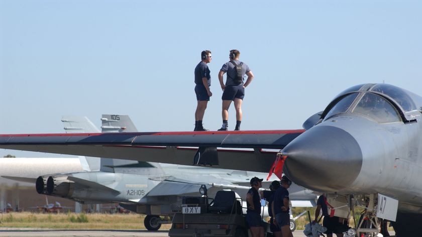 Groundcrew attend to an F-111 at RAAF Base Pearce.