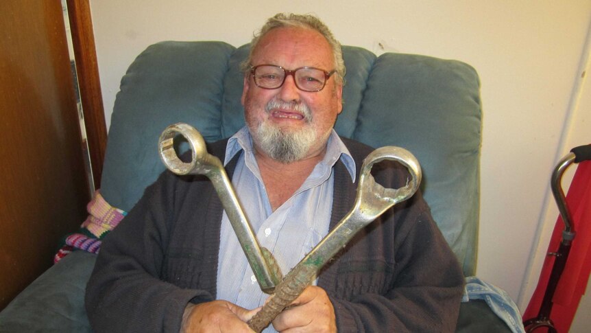 Max Hodge holding both ends of the modified spanner used in the construction of the Tasman Bridge.