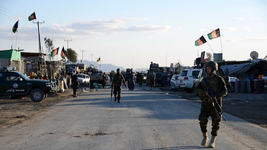 Afghan National Army soldiers stand alert after clashes against security forces at Kandahar Airport