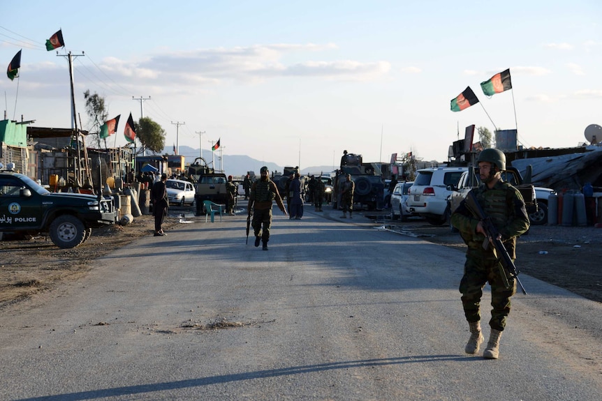 Afghan National Army soldiers stand alert after clashes against security forces at Kandahar Airport