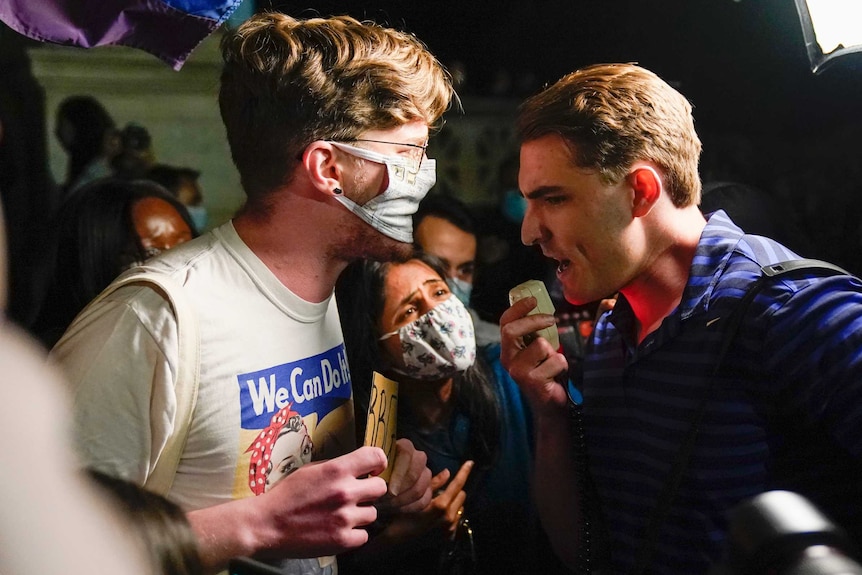 Two men having an argument during a spontaneous memorial for Ruth Bader Ginsburg