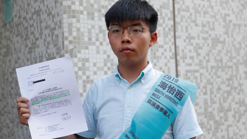 Joshua Wong, secretary-general of Hong Kong's pro-democracy Demosisto party, poses with the letter.