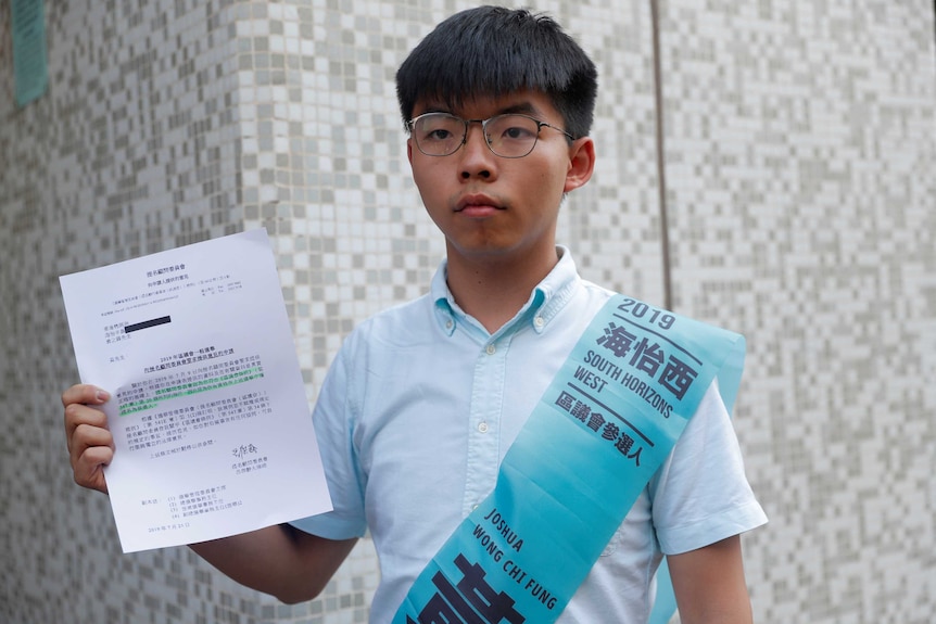 Joshua Wong, secretary-general of Hong Kong's pro-democracy Demosisto party, poses with the letter.