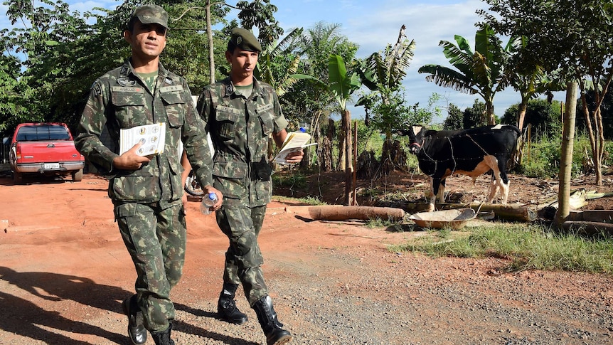 Brazilian soldiers hand out flyers about Zika virus