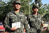 Brazilian soldiers hand out flyers about Zika virus