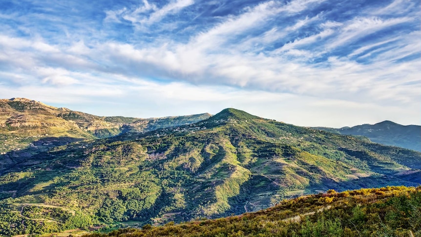A landscape view of a mountainous area of Lebanon against a blue sky.