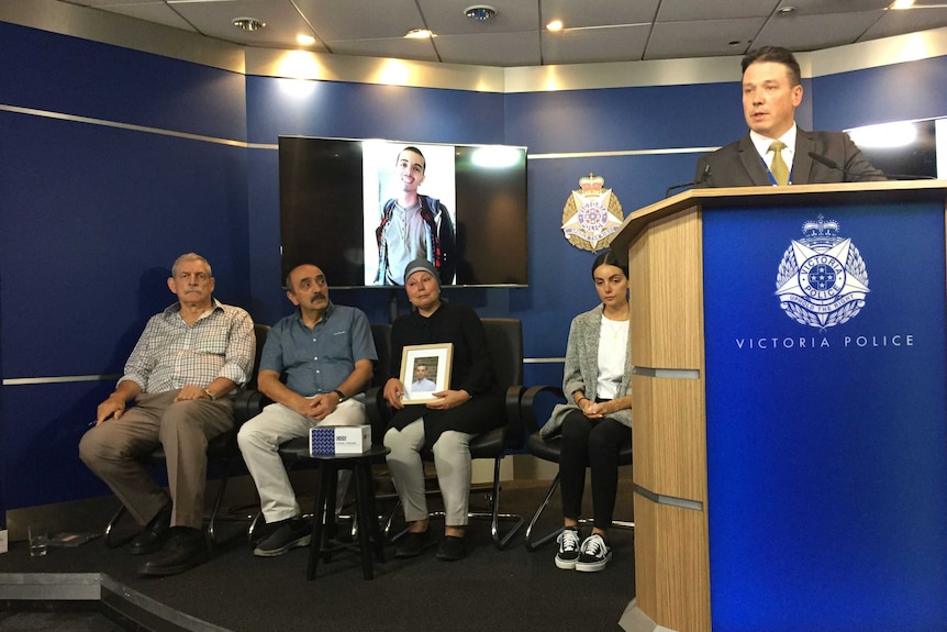 The Yucel family sit behind a podium during a police press conference.