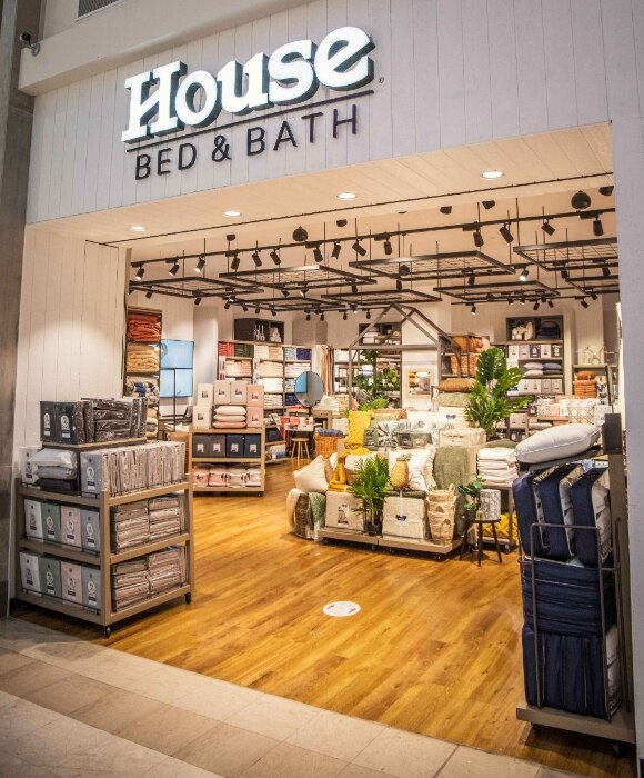 The exterior of House Bed & Bath, with homewares piled up.