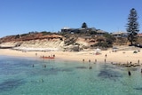 People swimming and snorkelling at the beach in a photo from the water