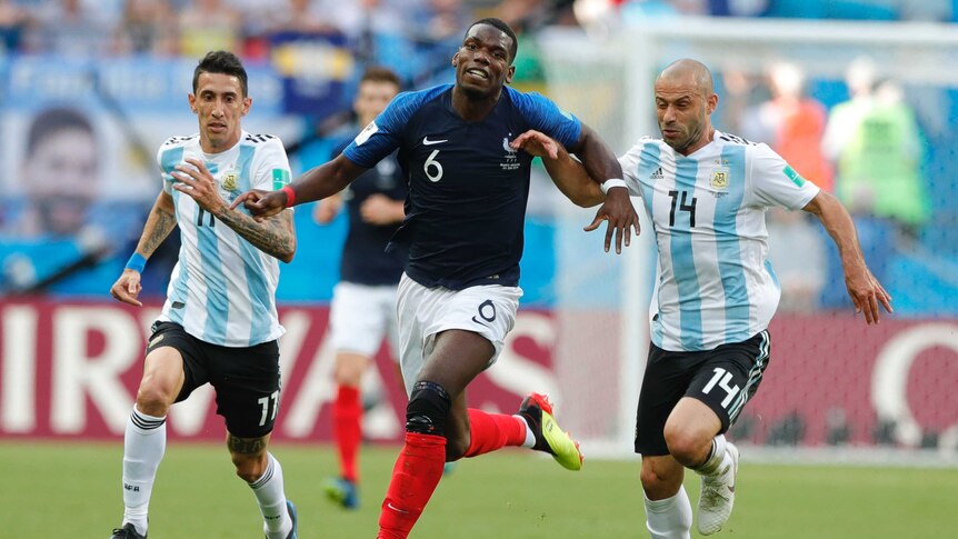 Paul Pogba battles for the ball against Argentina