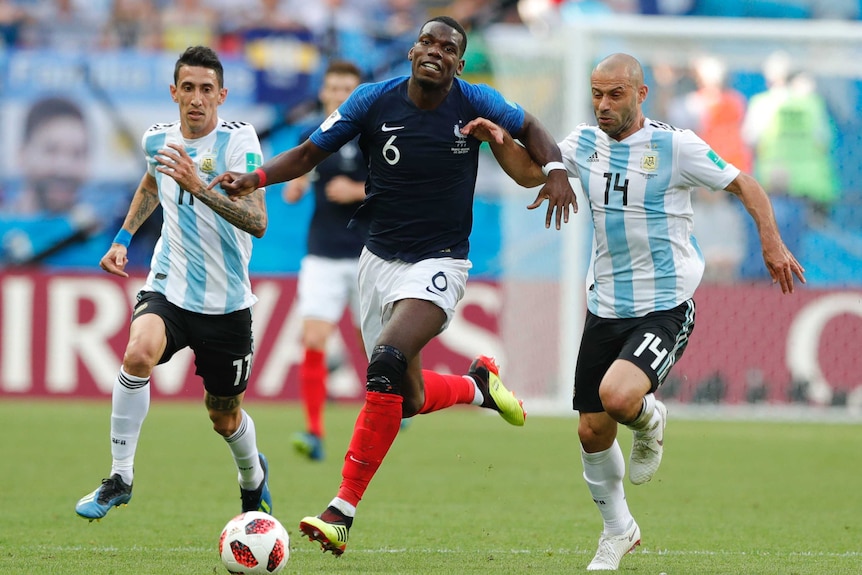 Paul Pogba battles for the ball against Argentina