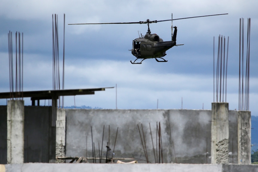 A military helicopter prepares to land as fighting continues in Marawi city, southern Philippines.