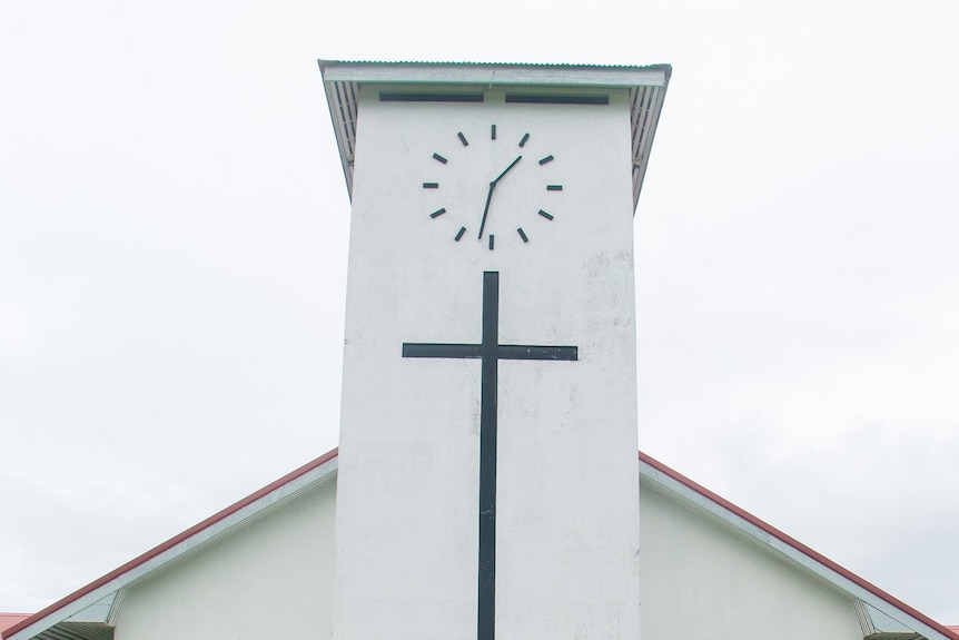 A photo of a church with a cross on it.