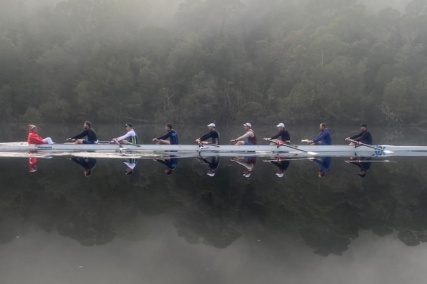 A row boat on a glassy lake on a misty day