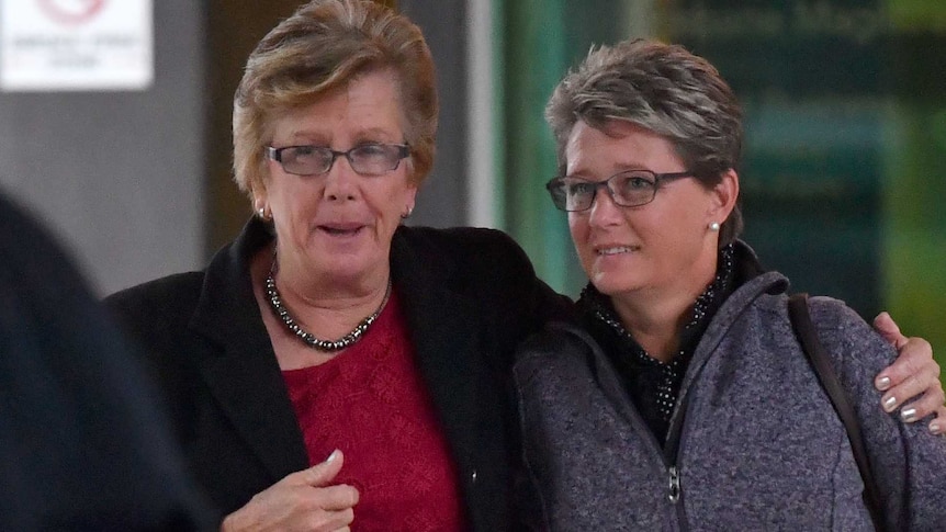 Queensland grazier Wendy Brauer (right) is seen leaving with a supporter.