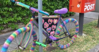 A crocheted rainbow bike.