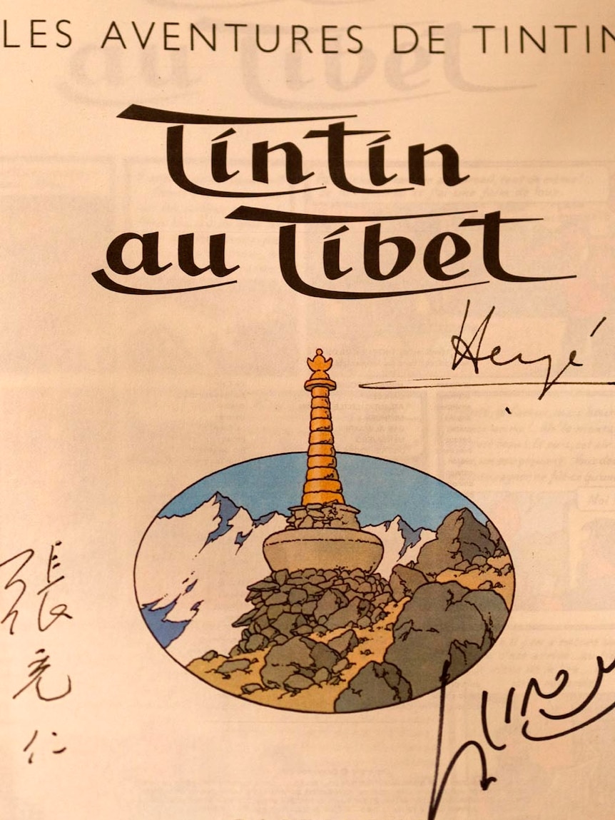 Front page of the comic The adventures of Tintin - Tintin au Tibet signed by the author Herge (R) and the Dalai Lama (R bottom).