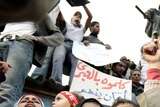Protesters chant anti-government slogans as they demonstrate in Tahrir Square