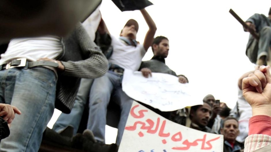 Protesters chant anti-government slogans as they demonstrate in Tahrir Square