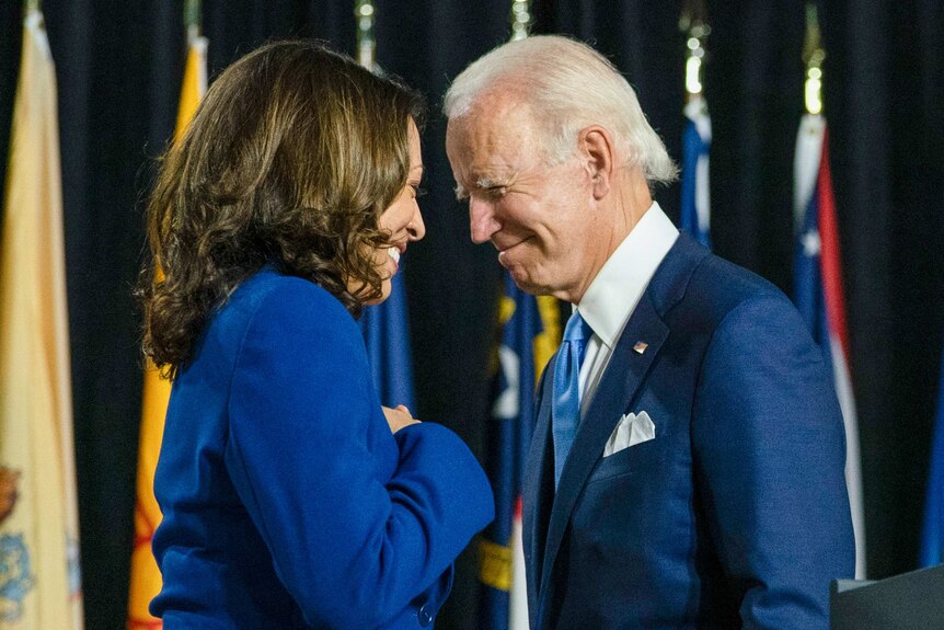 Kamala Harris and Joe Biden smile at each other