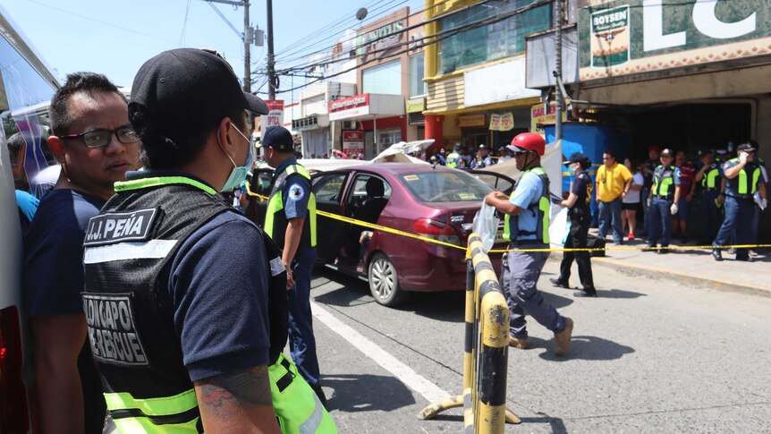 Police examine car after murders in Olongapo