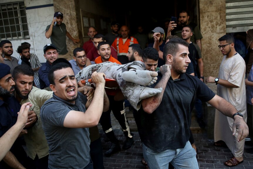 Mourners carry the body of Taiseer al-Jabari, Islamic Jihad commander, who was killed during Israeli airstrikes.