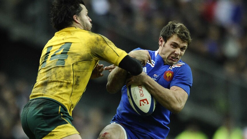 Adam Ashley-Cooper tries to stop French winger Vincent Clerc